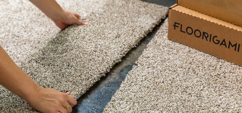 Image of Floorigami carpet tile being installed on the floor